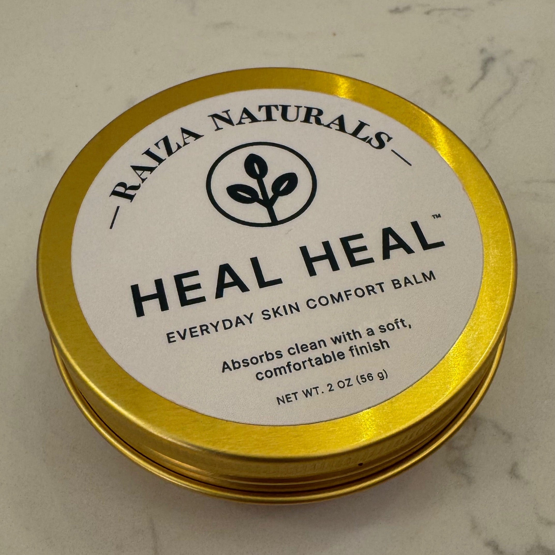 Heal Heal everyday skin comfort balm on a bathroom counter, used after washing for dry hands and everyday skin care