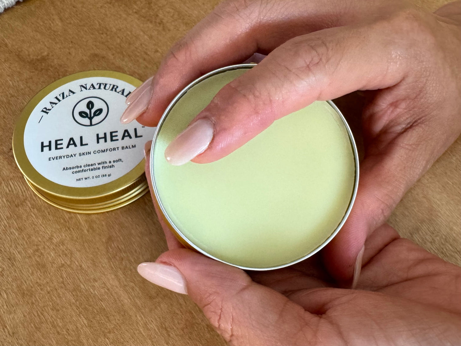 Finger applying Heal Heal balm showing smooth texture and clean absorption for everyday skin comfort